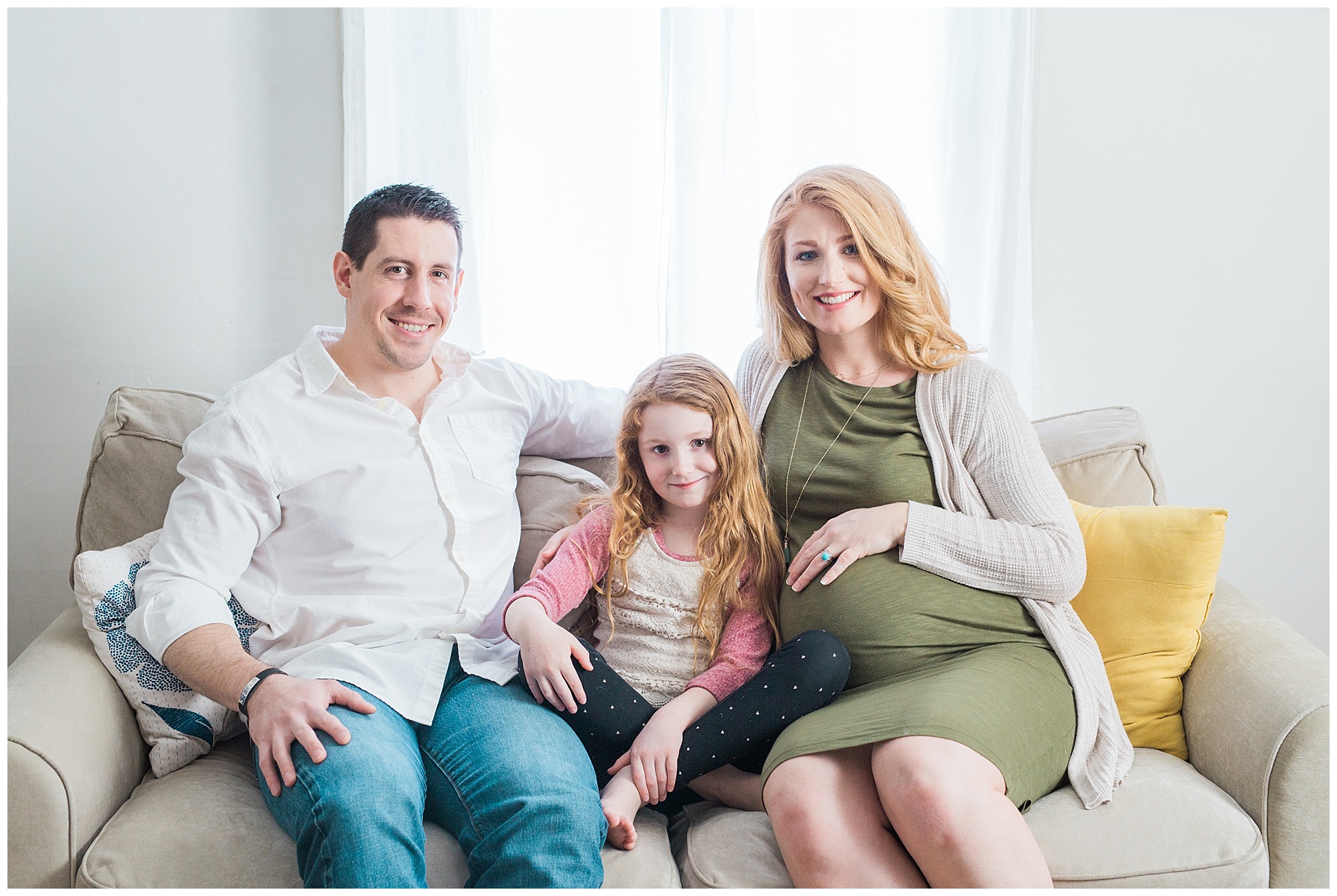 a redheaded pregnant woman and her family take maternity photos in her bangor, maine, home