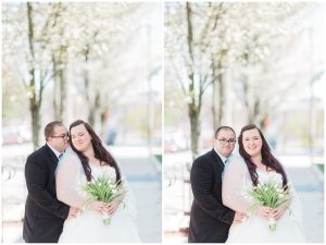 plus size couple in wedding attire taking wedding photos in downtown portland maine holding tulips