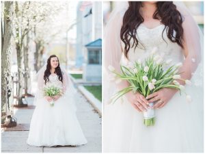 plus size couple in wedding attire taking wedding photos in downtown portland maine holding tulips