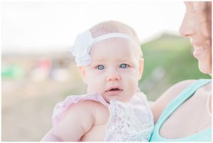 mommy and baby standing on the beach for a mommy and me session with her daughter