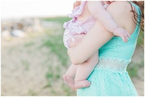 mommy and baby standing on the beach for a mommy and me session with her daughter