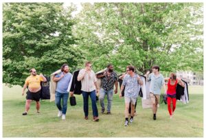 bride and groom get married at wedding venue tarry a while in bridgton maine. upscale luxury wedding with black tie groomsmen tuxes and black satin bridesmaid dresses, colorful flowers, summer maine wedding, lake, tent, outdoor dance floor, destination wedding