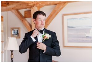 bride and groom get married at wedding venue tarry a while in bridgton maine. upscale luxury wedding with black tie groomsmen tuxes and black satin bridesmaid dresses, colorful flowers, summer maine wedding, lake, tent, outdoor dance floor, destination wedding