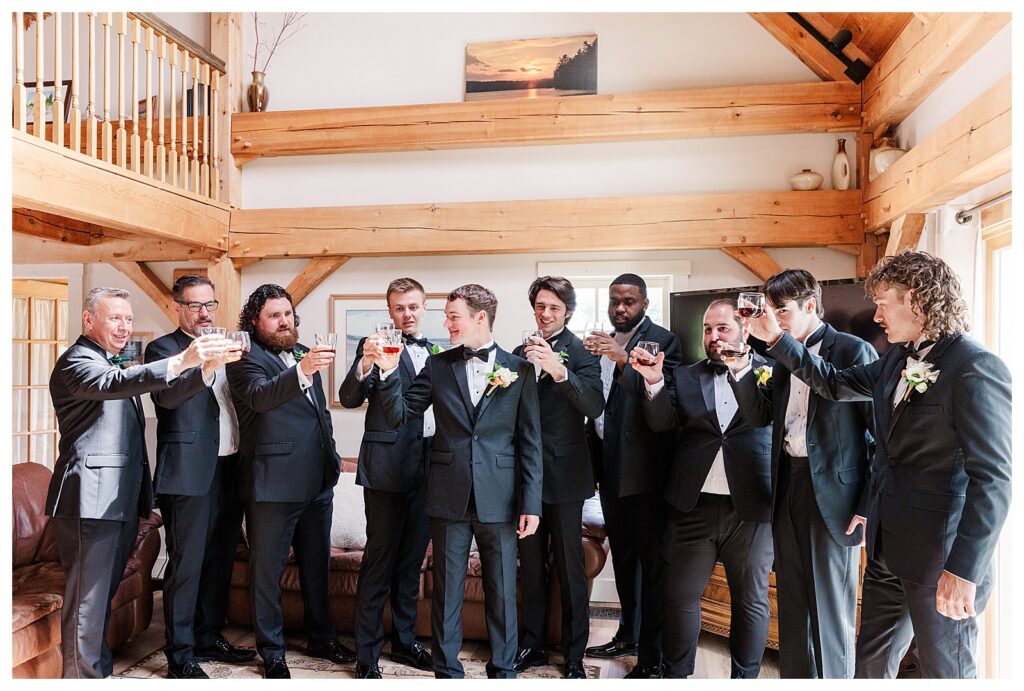 bride and groom get married at wedding venue tarry a while in bridgton maine. upscale luxury wedding with black tie groomsmen tuxes and black satin bridesmaid dresses, colorful flowers, summer maine wedding, lake, tent, outdoor dance floor, destination wedding