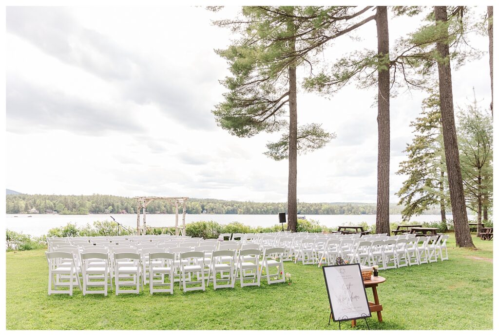 bride and groom get married at wedding venue tarry a while in bridgton maine. upscale luxury wedding with black tie groomsmen tuxes and black satin bridesmaid dresses, colorful flowers, summer maine wedding, lake, tent, outdoor dance floor, destination wedding