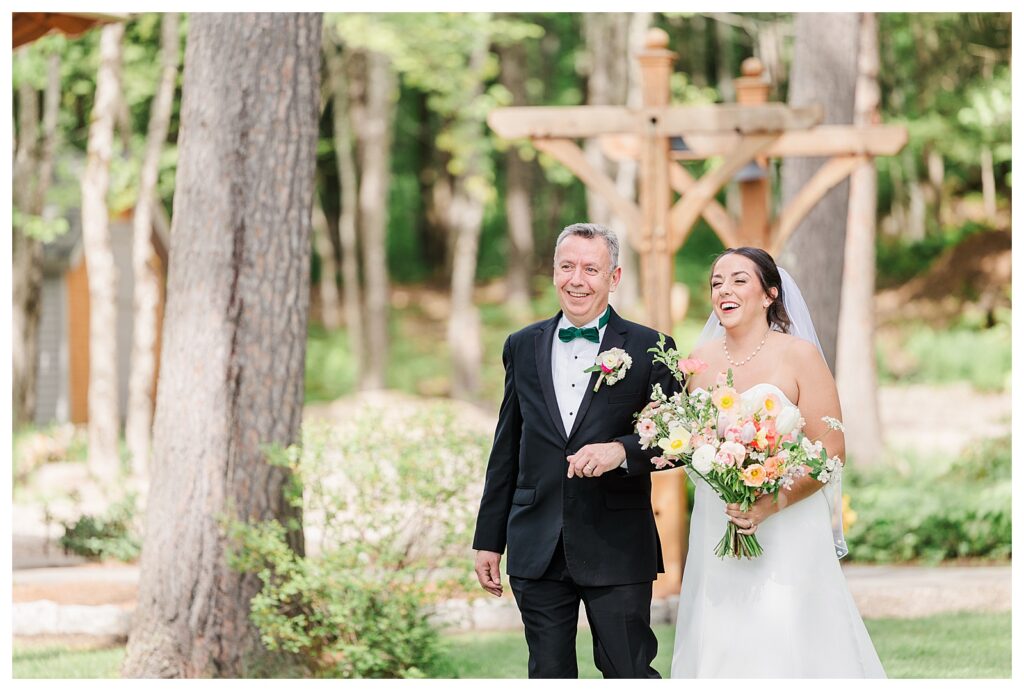 bride and groom get married at wedding venue tarry a while in bridgton maine. upscale luxury wedding with black tie groomsmen tuxes and black satin bridesmaid dresses, colorful flowers, summer maine wedding, lake, tent, outdoor dance floor, destination wedding