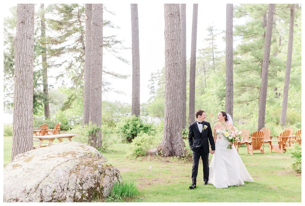 bride and groom get married at wedding venue tarry a while in bridgton maine. upscale luxury wedding with black tie groomsmen tuxes and black satin bridesmaid dresses, colorful flowers, summer maine wedding, lake, tent, outdoor dance floor, destination wedding