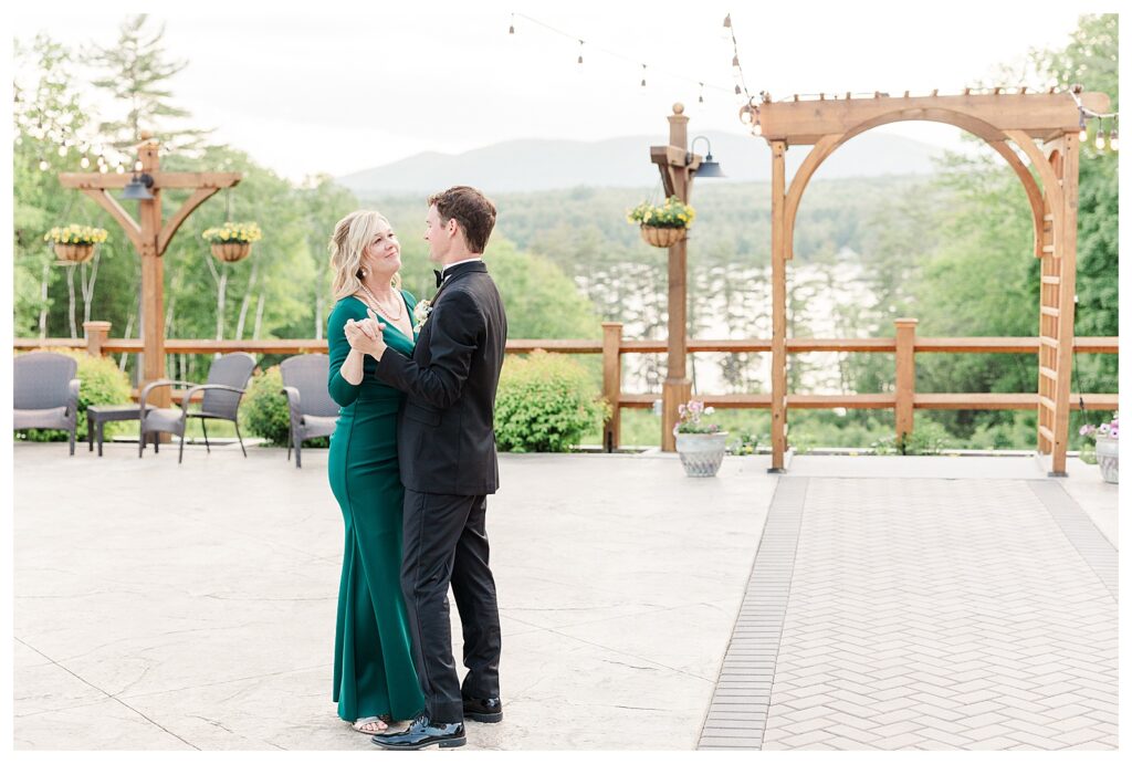 bride and groom get married at wedding venue tarry a while in bridgton maine. upscale luxury wedding with black tie groomsmen tuxes and black satin bridesmaid dresses, colorful flowers, summer maine wedding, lake, tent, outdoor dance floor, destination wedding